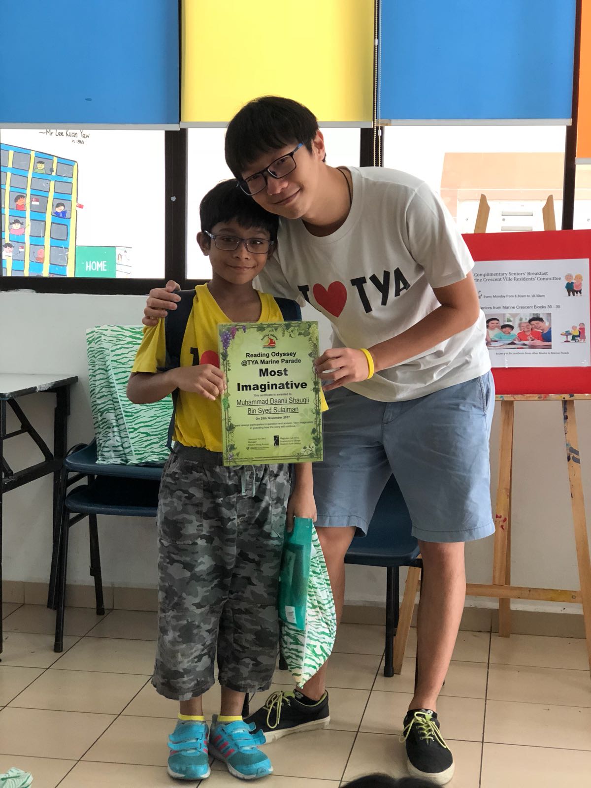 A volunteer mentor with a child after their academic coaching session.