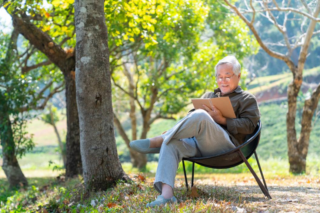 A man reads a book in the great outdoors. Make time for yourself to do the things you love.